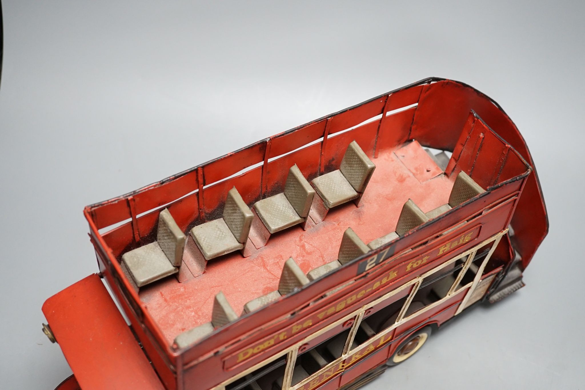 A reproduction tinplate double decker topless bus, the side reading ‘Don’t be vague - ask for Haig’, 42cm long